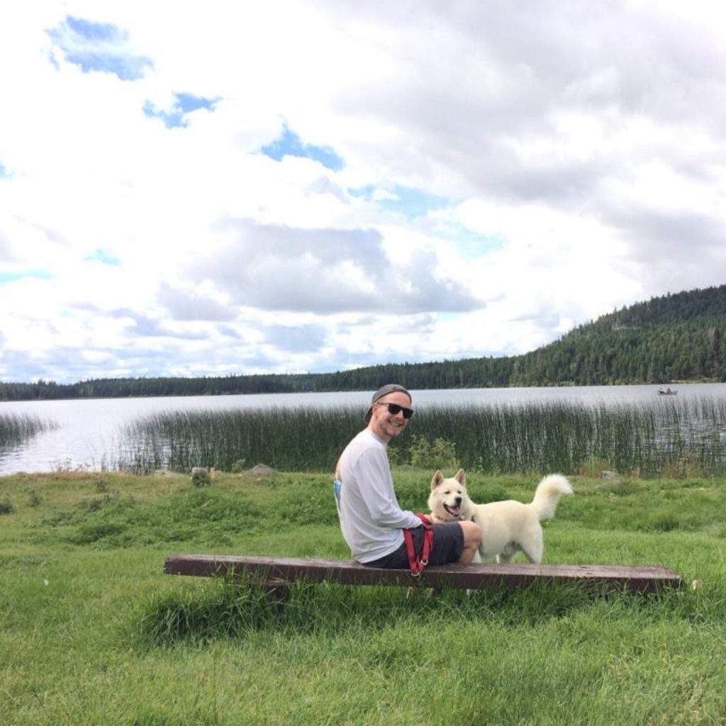 Monday's creative director, Matthew Johnson, with his dog Batman pictured at Peter Hope Lake in British Columbia.