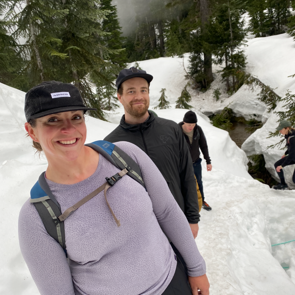 A few crew members hike in the snow